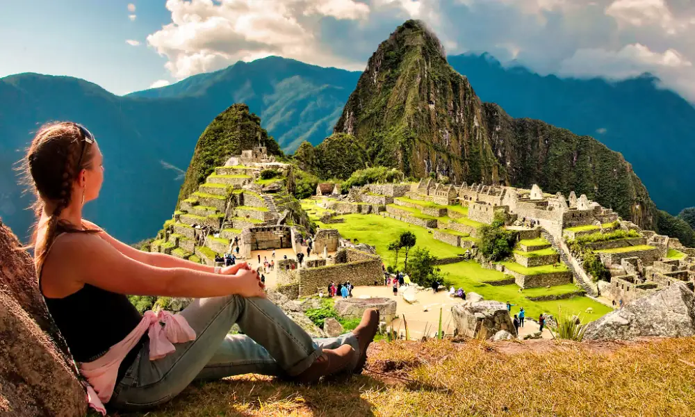 Beautiful lady enjoying a view of Machupicchu